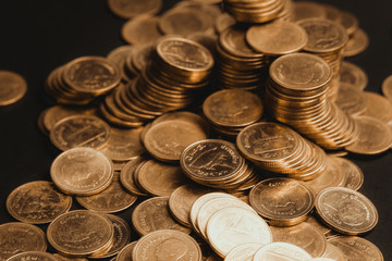 Savings, increasing columns of coins, piles of coins arranged as a graph in dark room, business banking concept.