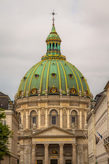 Obraz premium Amalienborg Palace in Copenhagen, Denmark. Surrounding the palace square with its statue of King Frederik V from 1771, Amalienborg is made up of four identical buildings.