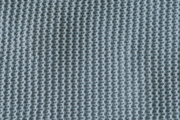 Dark green texture of the knitted fabric Vertical view.