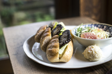 appetizing roll with grilled vegetables on wooden background