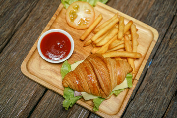 Croissant ham cheese delicious breakfast on wooden table