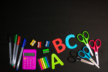 Back to school background. Top view of school supplies on chalkboard 