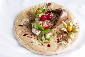 Chocolate dessert Mother's plant with cream and fresh fruits on round board