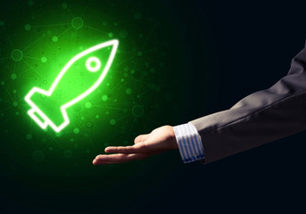 Man palm presenting Rocket web icon as technology concept