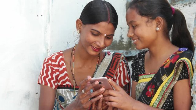 Close up women dress colorful buddies laugh and share photo video secrets love on the phone laugh thumbs up congratulate well done wow fantastic awesome joy ecstatic tilt down shot two medium shot 