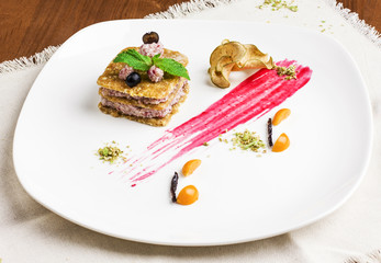 Raw food vegan dessert with berries and mint on white plate