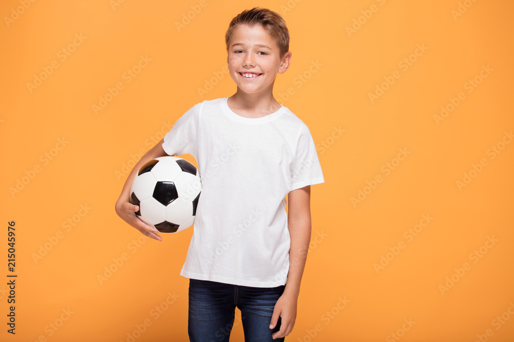 Wall mural happy little boy with soccer ball.