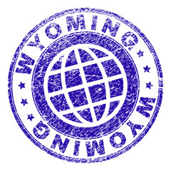 WYOMING stamp imprint with distress texture. Blue vector rubber seal imprint of WYOMING label with grunge texture. Seal has words arranged by circle and globe symbol.