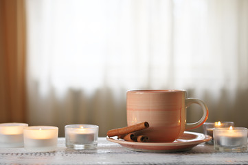 Cup of coffee and burning candles