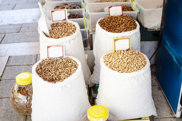 Nuts in large white bags on the market