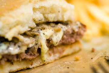 american beef hamburger with cheese and french fries at beautiful fast food and cafe bistro.delicious low price hamburger in budget.close up details of hamburger and chicken nuggets at fast food.