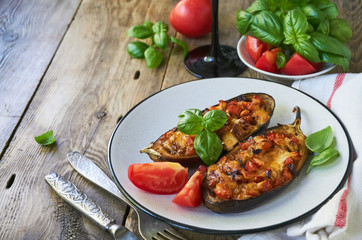 Stuffed eggplants with tomatoes and cheese on a plate