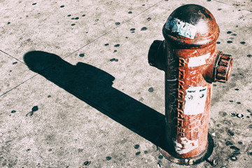 Wallpaper background of an old red fire hydrant in the street. Fire hydrant for emergency fire...
