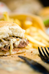 american beef hamburger with cheese and french fries at beautiful fast food and cafe bistro.delicious low price hamburger in budget.close up details of hamburger and chicken nuggets at fast food.
