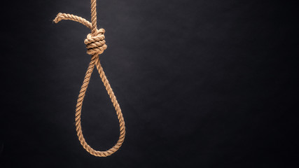 Noose. The concept of murder or suicide. On dark background