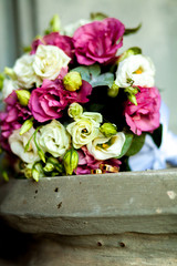 close-up of wedding rings on background wedding bouquet of roses of berries and greens with lavender