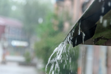 Storm rain drips down from the roof