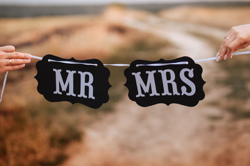 Funny bride and groom with Mr and Mrs signs. Happy wedding day