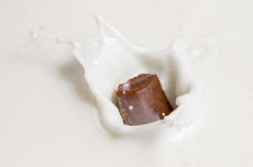 Chocolate falls in milk