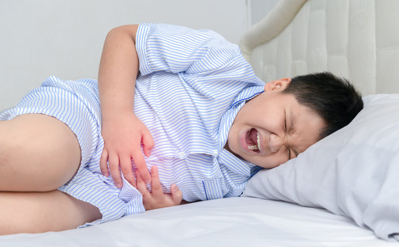 asian fat child suffering from stomachache