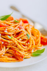 Pasta dish with tomato sauce on white plate