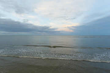 Fototapeta na wymiar Inspirational of sea and sky background. Soft waves on sandy beach. Sunset landscape
