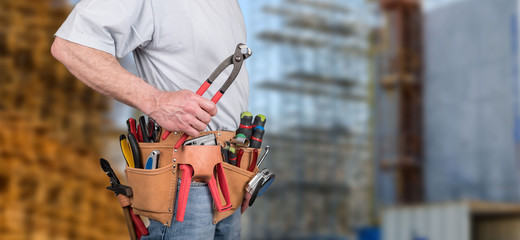 Building worker with tool belt