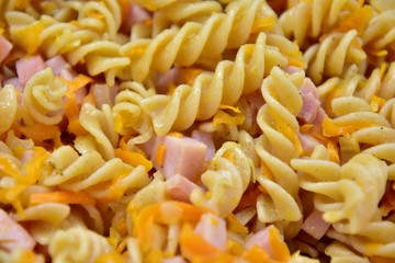 Pasta fried with sausage, onions and carrots. Bachelor meals. Unhealthy food. Fast food. Solid background