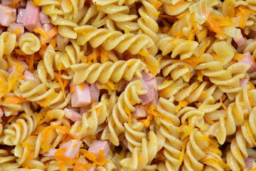 Pasta fried with sausage, onions and carrots. Bachelor meals. Unhealthy food. Fast food. Solid background