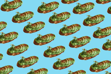 Background of a lot of delicious and nutritious veggie toasts or sandwiches with avocado and guacamole in a minimal style.