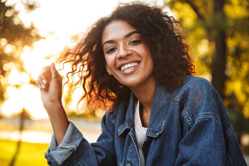 Smiling young african girl in denim jacket