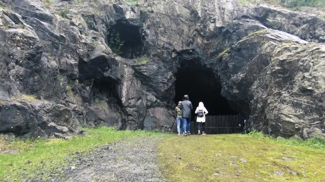 slow motion shot of people walking into the cave