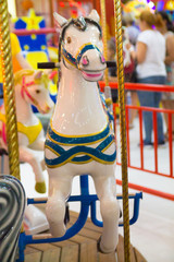 colorful merry-go-round horse in an amusement park