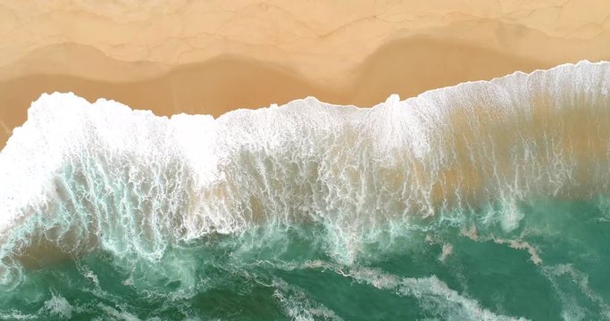 4k aerial view waves breaking on the beach, 60fps frames per second