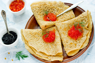 Traditional russian pancakes blini with red and black caviar