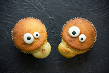 Halloween funny monster cakes with candy eyes for treat kids