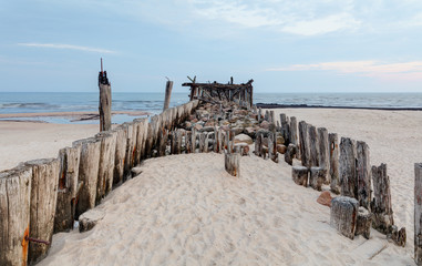 An old wooden pier. Early morning at sea shore.
