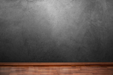 Concrete wall in a room with a wooden brown floor