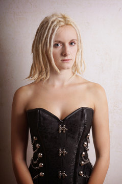 young woman with blonde dreadlocks and black corsage