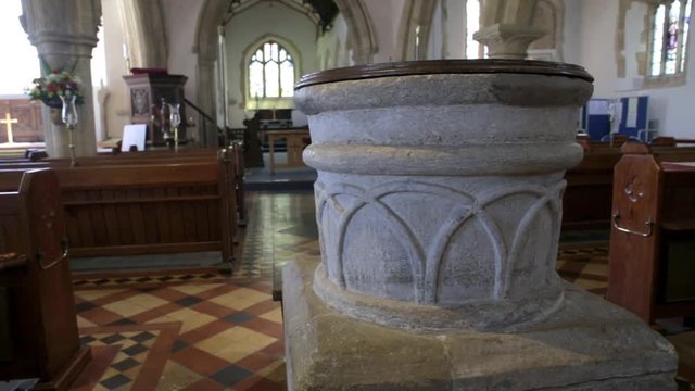 Old stone baptismal font in medieval church SLIDER SHOT