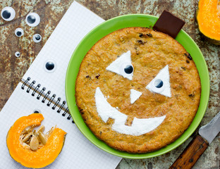 Pumpkin pie with jack-o-lantern face - traditional dessert for Halloween or Thanksgiving feast