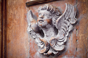 Sculpture of a wooden angel - more than 100 years old - toned image with copy space
