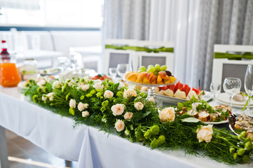 Main wedding table decorated with huge beautiful flower piece in the centre.