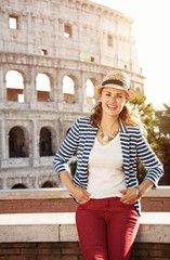 happy stylish woman in front of Colosseum in Rome, Italy