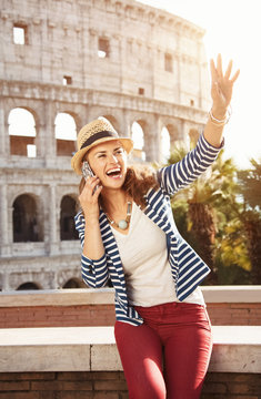 woman near Colosseum speaking on mobile phone and handwaving