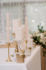 A line of different candles on a table.