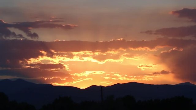 Colorado Rocky Mountains orange sunset with clouds time lapse