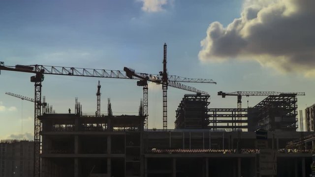 Cranes working day and night on construction of the housing estate in former industrial zone, time lapse