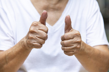 Senior woman's hand symbol meaning 