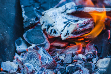 Burning coals in the grill. Shallow depth of field.